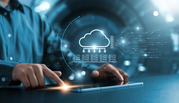 A person uses a tablet with a glowing cloud computing icon and digital data graphics hovering above
