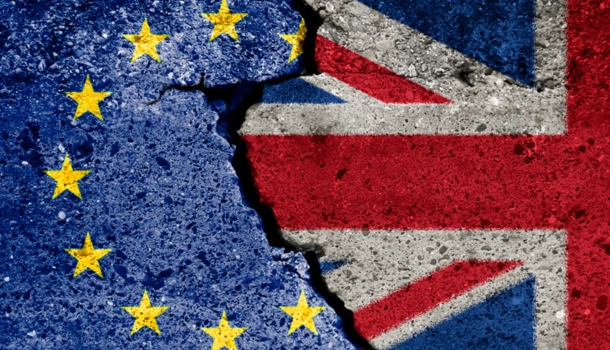A cracked concrete surface showing the European Union flag on the left and the United Kingdom flag on the right