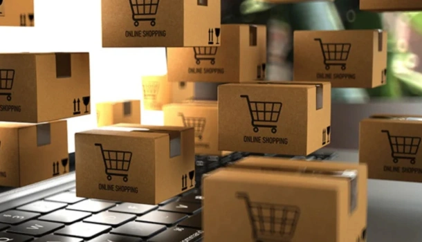Small cardboard boxes with shopping cart icons and "Online Shopping" labels appear to float above a laptop keyboard