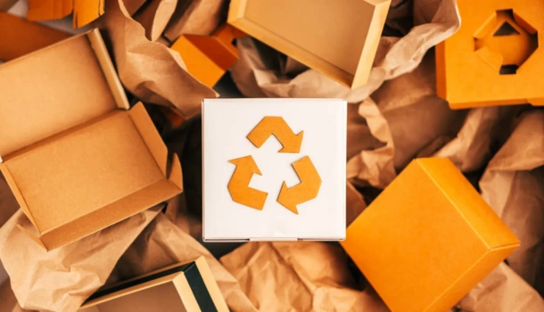 A white box with a brown recycling symbol surrounded by eco-friendly cardboard packaging