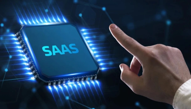 A hand reaching toward a glowing microchip labeled "SAAS"
