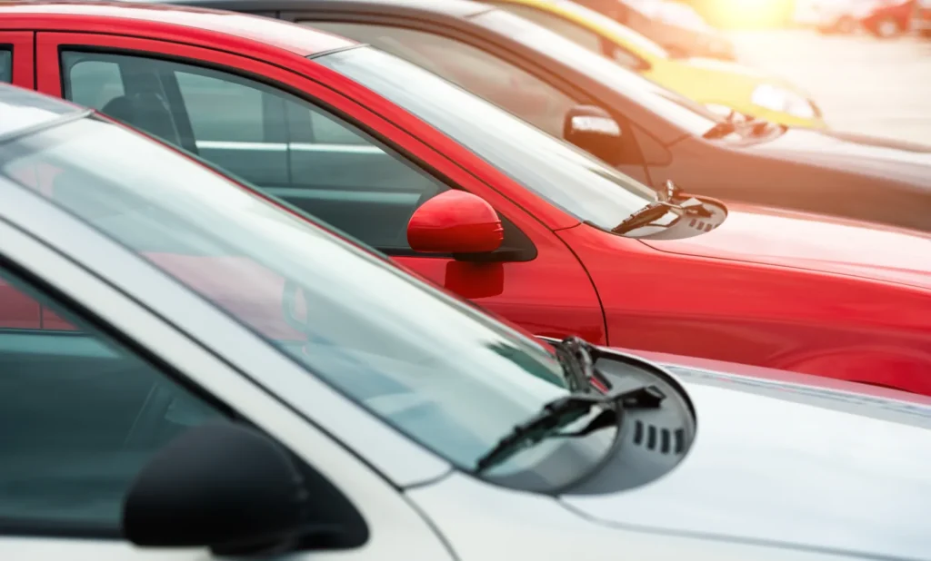 A row of parked cars in various colors