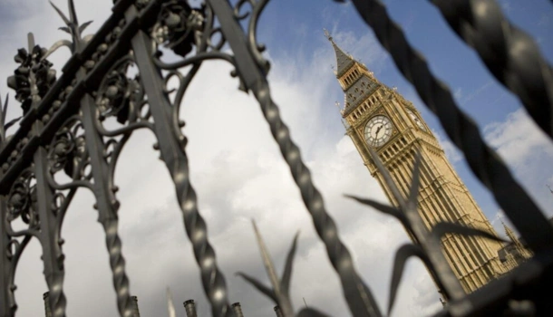 The Elizabeth Tower, commonly known as Big Ben, is seen through ornate black railings