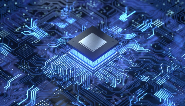 A glowing computer microchip sits at the center of a complex circuit board, symbolizing advanced semiconductor technology